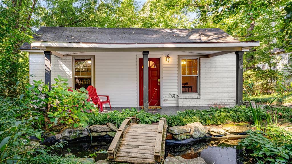 a front view of a house with yard and outdoor seating