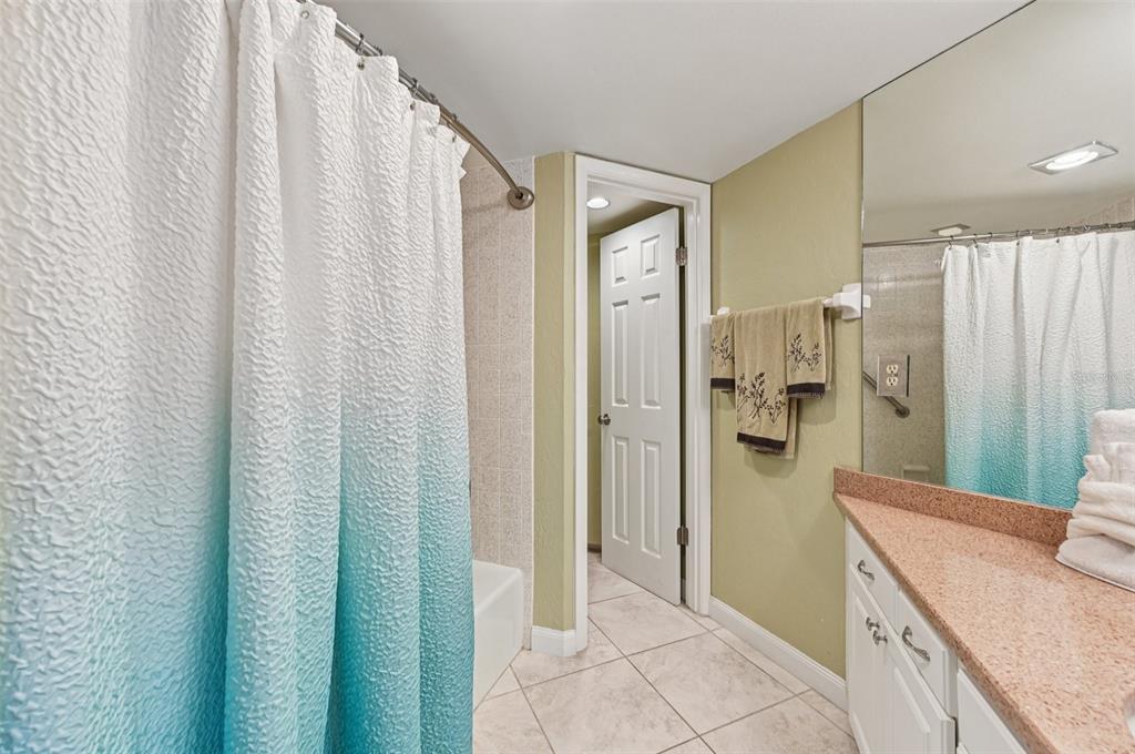 8710 Midnight Pass Road, Unit 203 Sarasota, FL 34242 - Photo 24 of 41 a bathroom with a shower and a sink