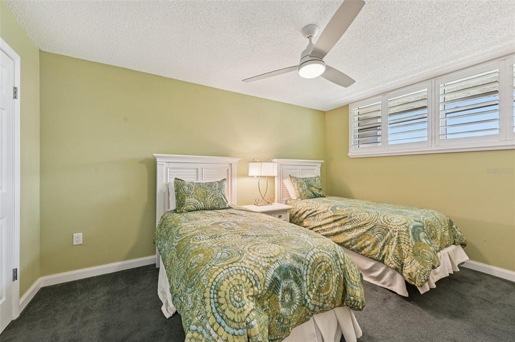 8710 Midnight Pass Road, Unit 203 Sarasota, FL 34242 - Photo 27 of 41 a bedroom with a bed and a painting on the wall