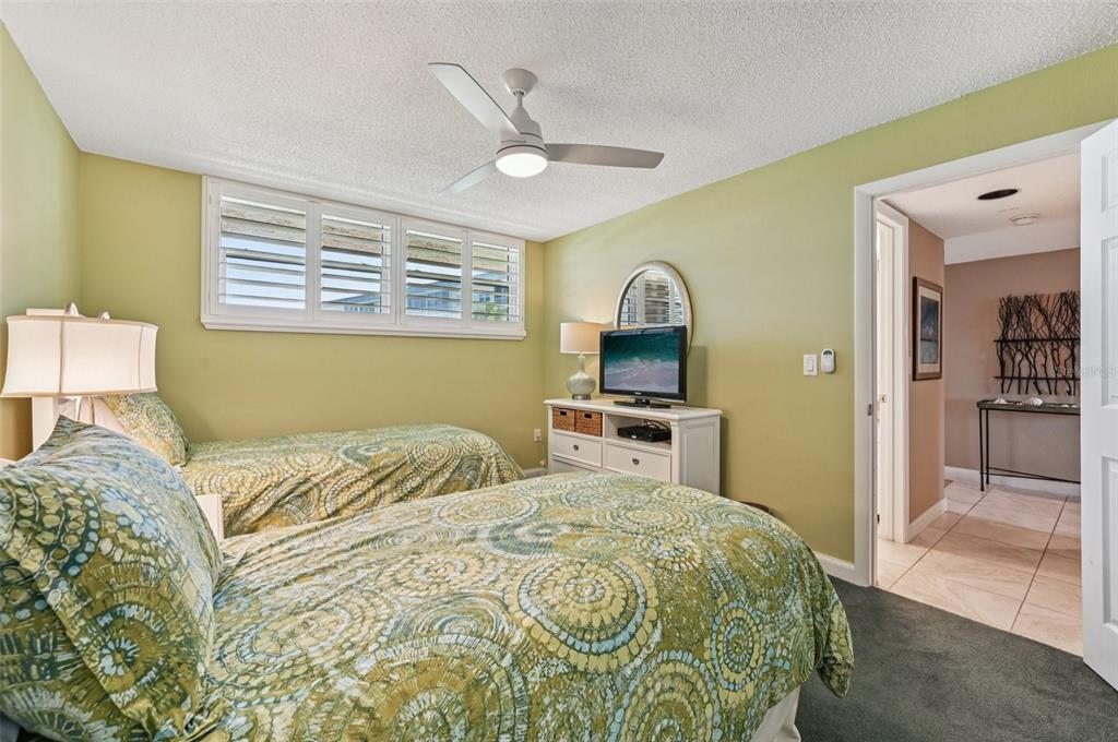 8710 Midnight Pass Road, Unit 203 Sarasota, FL 34242 - Photo 28 of 41 a bedroom with a bed and a television