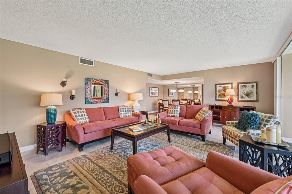 8710 Midnight Pass Road, Unit 203 Sarasota, FL 34242 - Photo 3 of 41 a living room with furniture a rug and a table