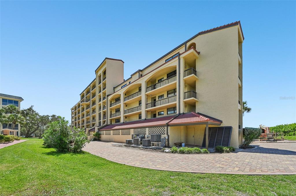 8710 Midnight Pass Road, Unit 203 Sarasota, FL 34242 - Photo 33 of 41 a view of building with yard
