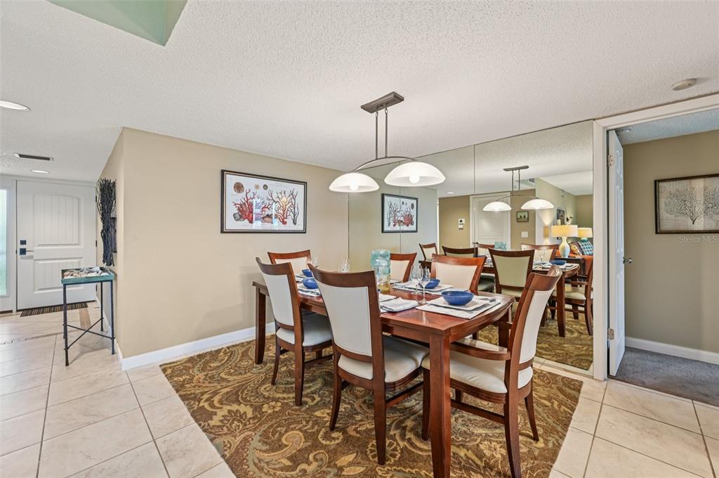 8710 Midnight Pass Road, Unit 203 Sarasota, FL 34242 - Photo 8 of 41 a view of a dining room with furniture