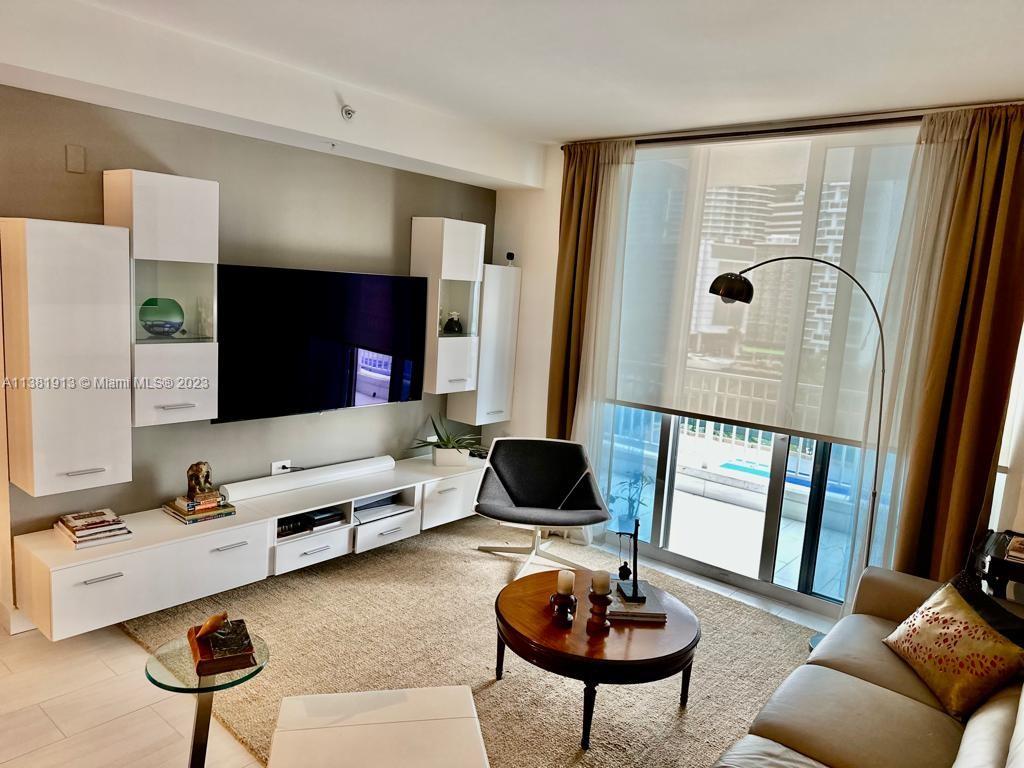 801 Brickell Key Boulevard, Unit 908 Miami, FL 33131 - Photo 11 of 29 a living room with furniture and a large window