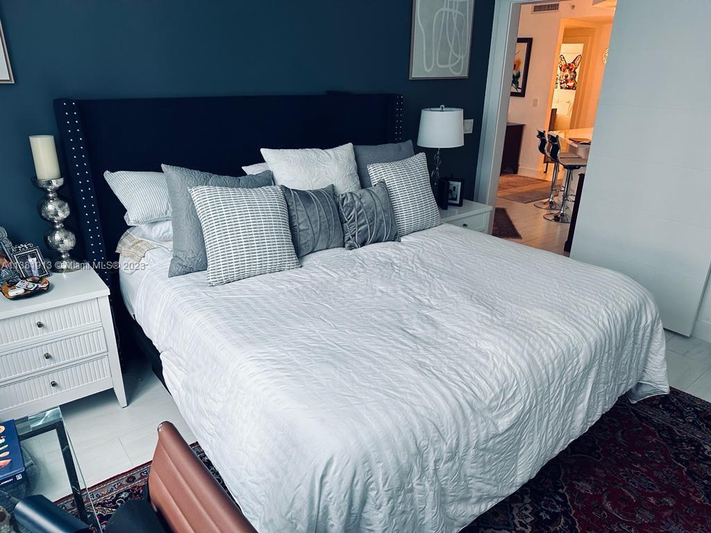 801 Brickell Key Boulevard, Unit 908 Miami, FL 33131 - Photo 14 of 29 a bedroom with a bed and window