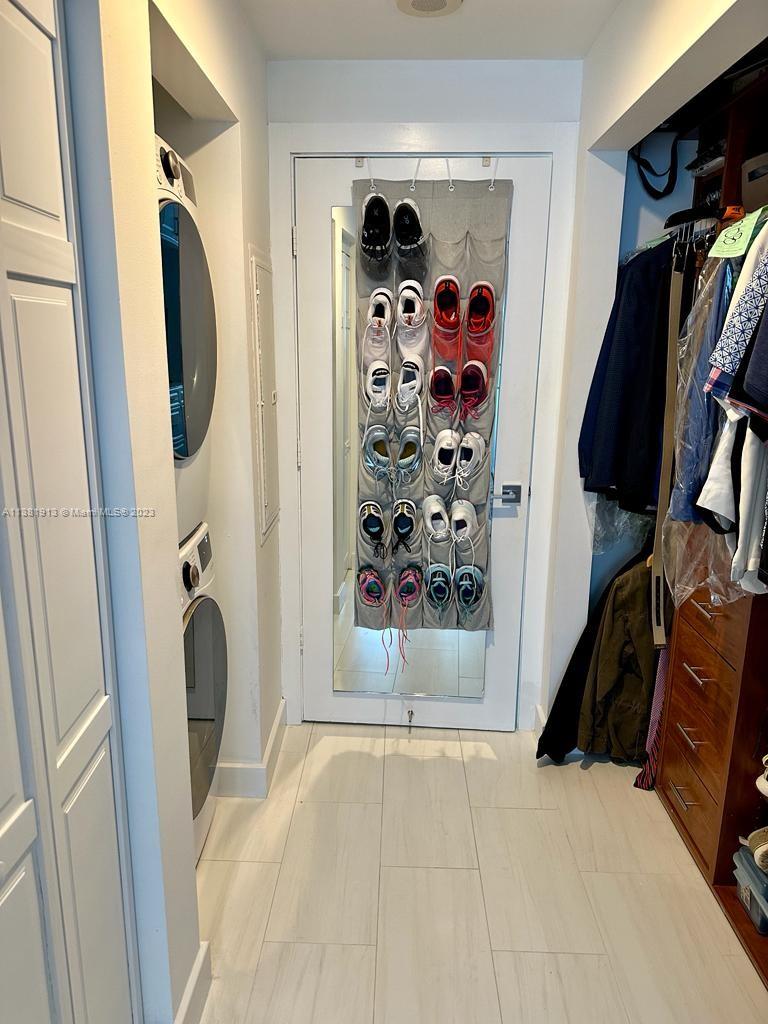801 Brickell Key Boulevard, Unit 908 Miami, FL 33131 - Photo 16 of 29 a view of walk in closet with clothes and shoes