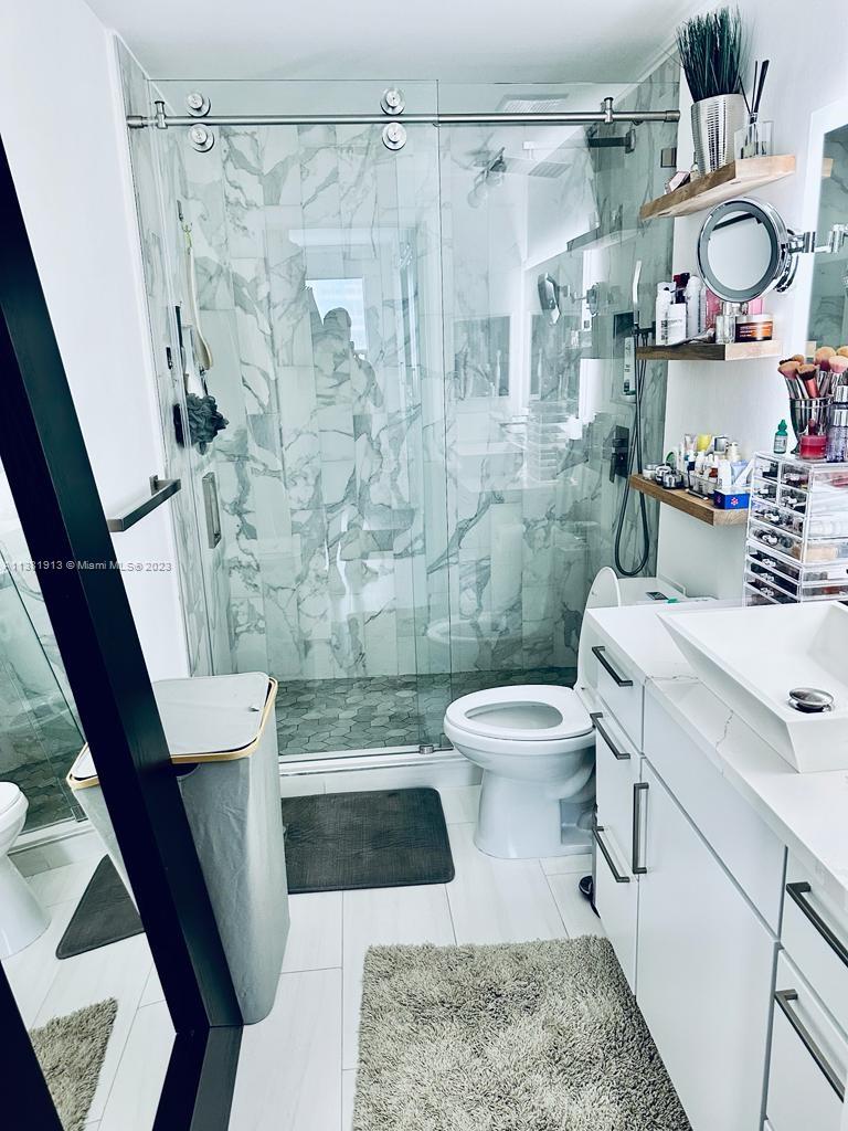 801 Brickell Key Boulevard, Unit 908 Miami, FL 33131 - Photo 18 of 29 a bathroom with a sink a toilet and shower