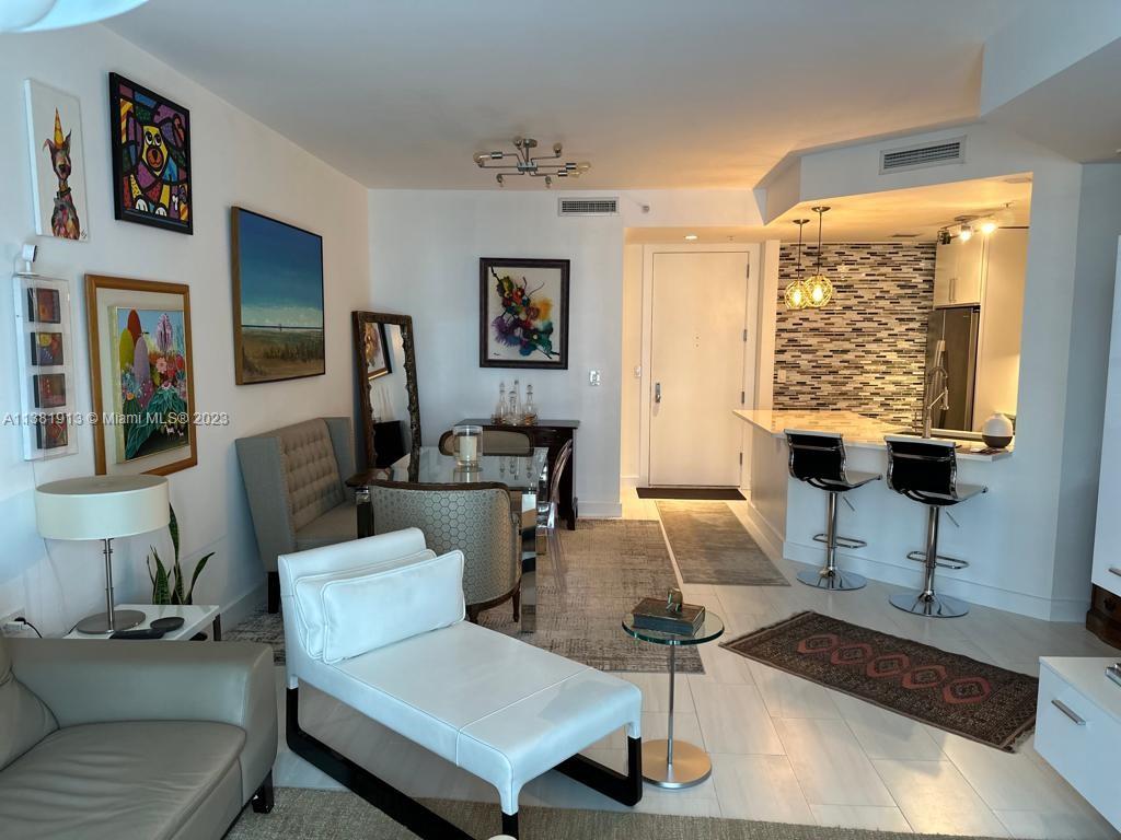 801 Brickell Key Boulevard, Unit 908 Miami, FL 33131 - Photo 9 of 29 a living room with furniture and a window