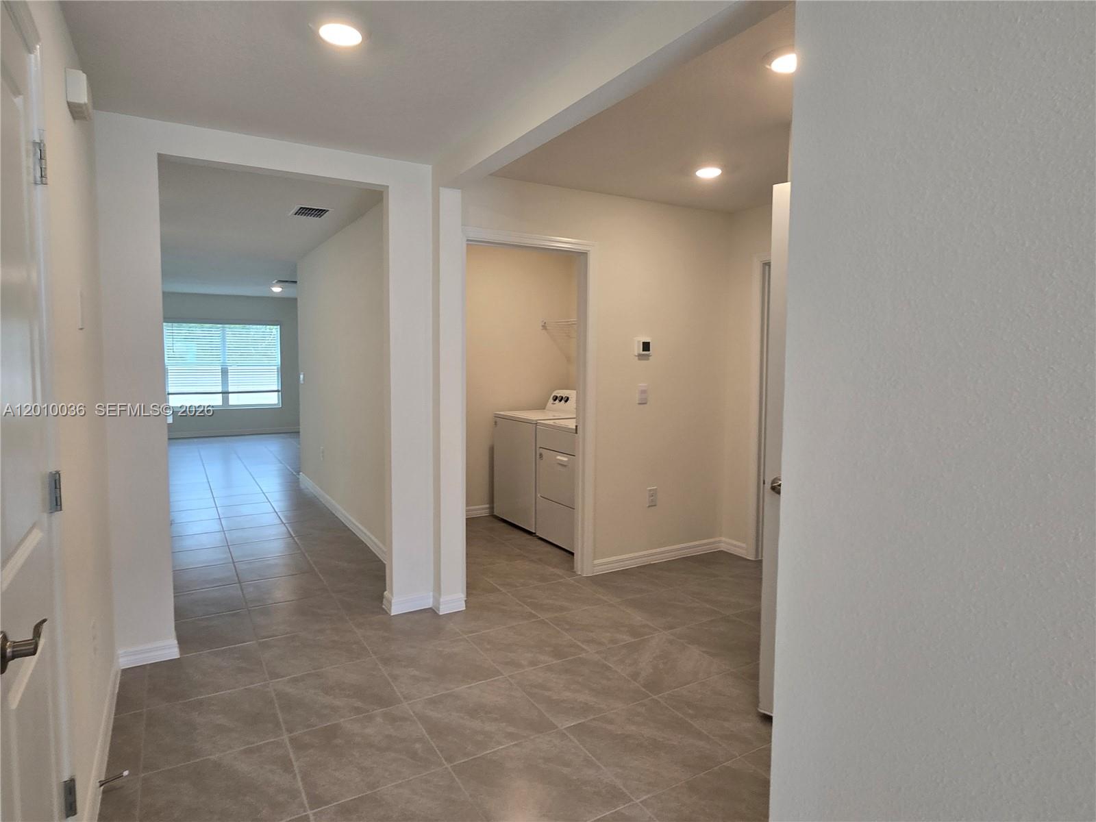 9871 Southeast 161st Lane Road Summerfield, FL 34491 - Photo 8 of 31 a view of a hallway with wooden floor and a bathroom