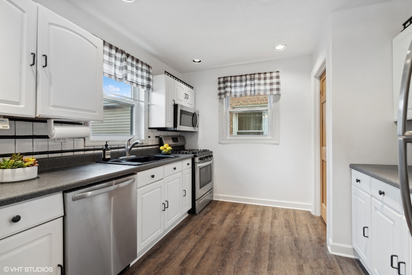 1437 Elgin Avenue Forest Park, IL 60130 - Photo 2 of 13 a kitchen with sink cabinets and wooden floor