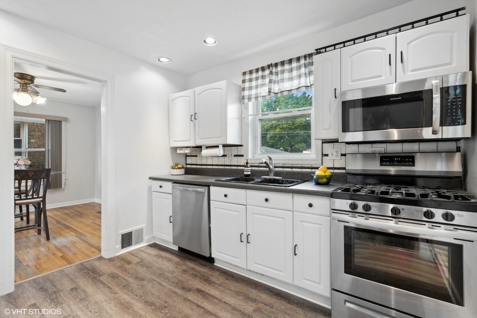 1437 Elgin Avenue Forest Park, IL 60130 - Photo 3 of 13 a kitchen with stainless steel appliances granite countertop a stove microwave and cabinets