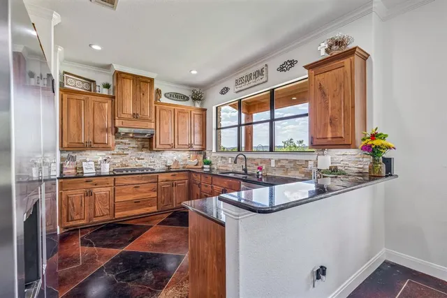 a kitchen with stainless steel appliances granite countertop a refrigerator and sink