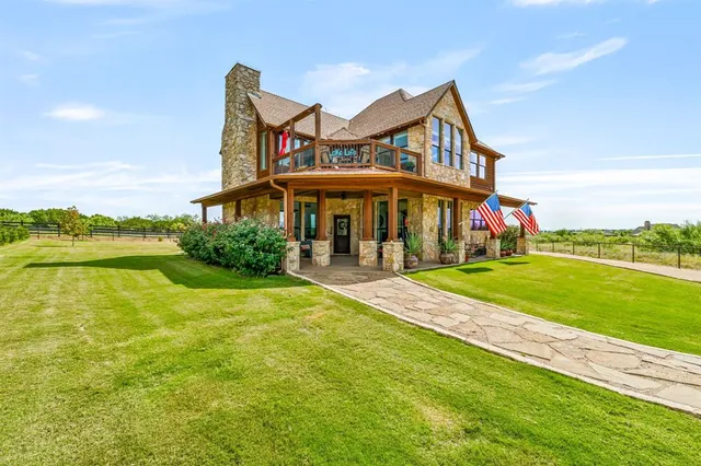 a front view of a house with a yard table and chairs