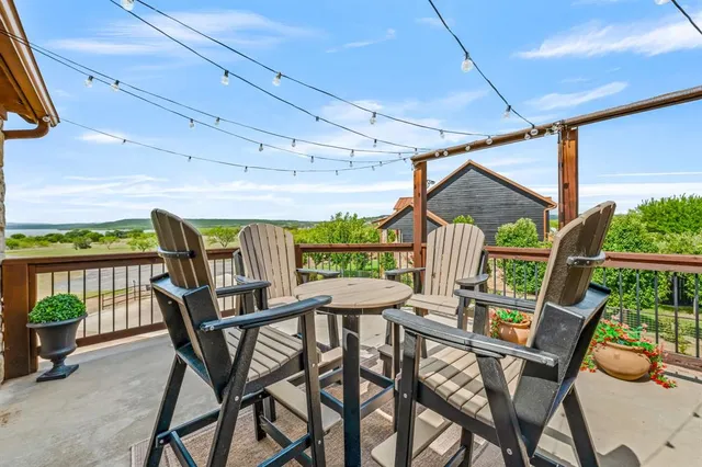 a view of a patio with a table and chairs