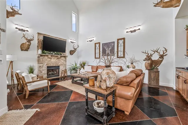 a living room with fireplace furniture and a flat screen tv
