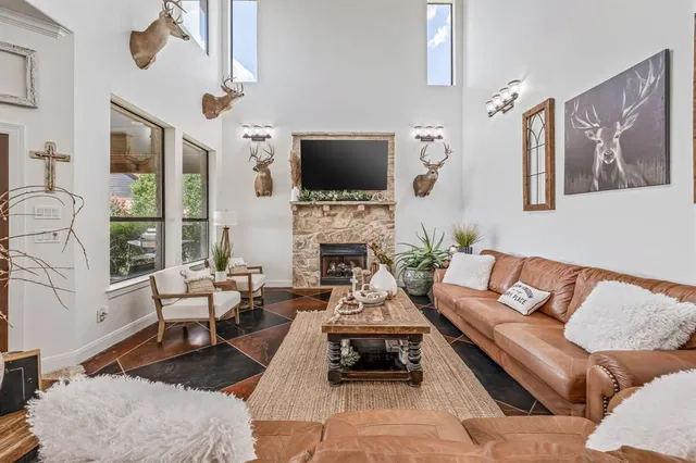 a living room with furniture a flat screen tv and a fireplace