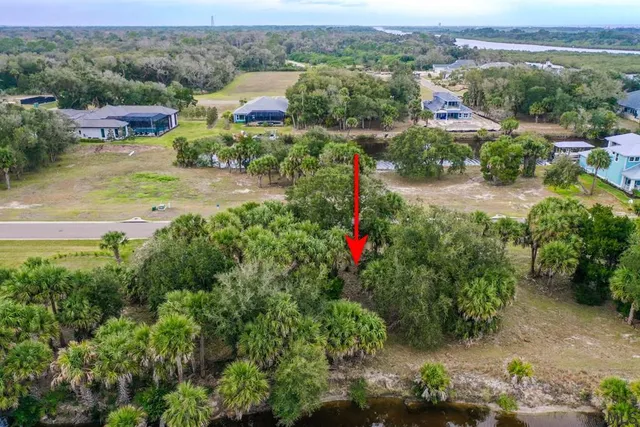 an aerial view of residential houses with outdoor space and swimming pool