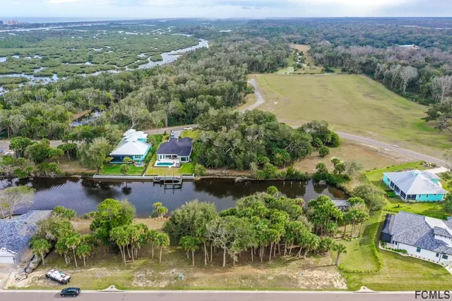 an aerial view of a house with a lake view