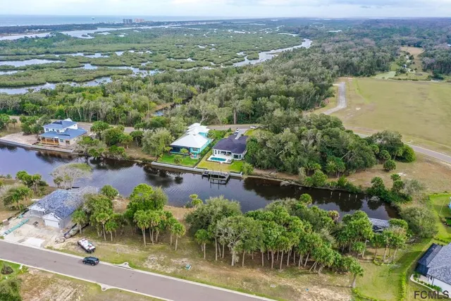 an aerial view of a house with a lake view