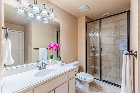 a bathroom with a toilet and a shower