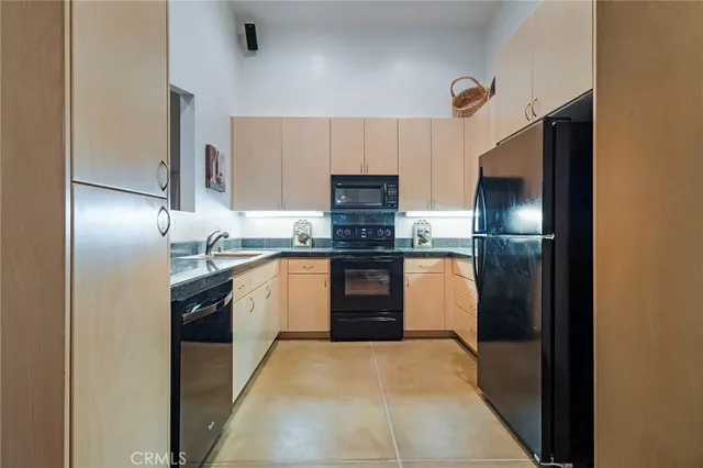 a kitchen with a refrigerator and a sink