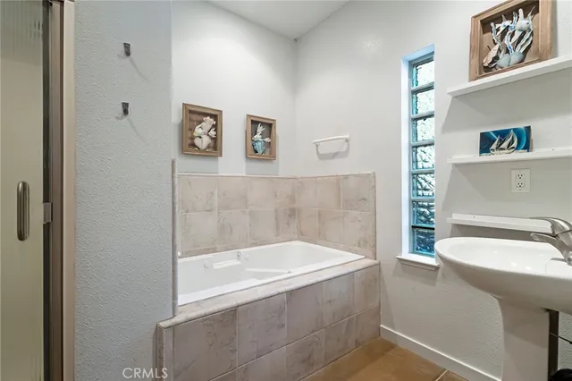 a bath tub sitting next to a bathroom sink