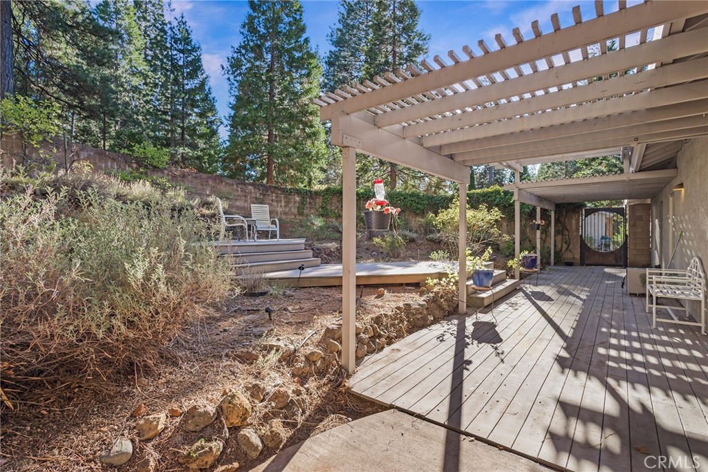 4911 Contentment Lane Forest Ranch, CA 95942 - Photo 7 of 30 a view of a patio with table and chairs with wooden floor and fence