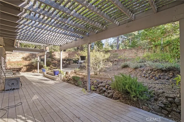 a view of a porch with furniture and wooden floor