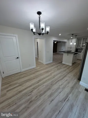 a view of a living room and kitchen with a wooden floor