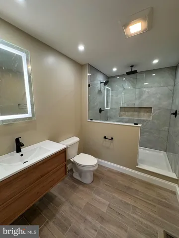 a bathroom with a sink a toilet and a mirror