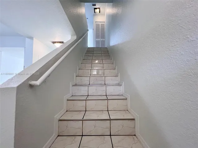 a view of a storage and utility room with washer and dryer