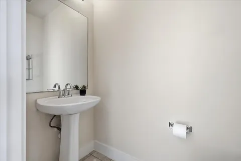 a bathroom with a sink a mirror and a window
