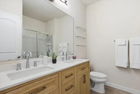 a bathroom with a toilet sink and mirror