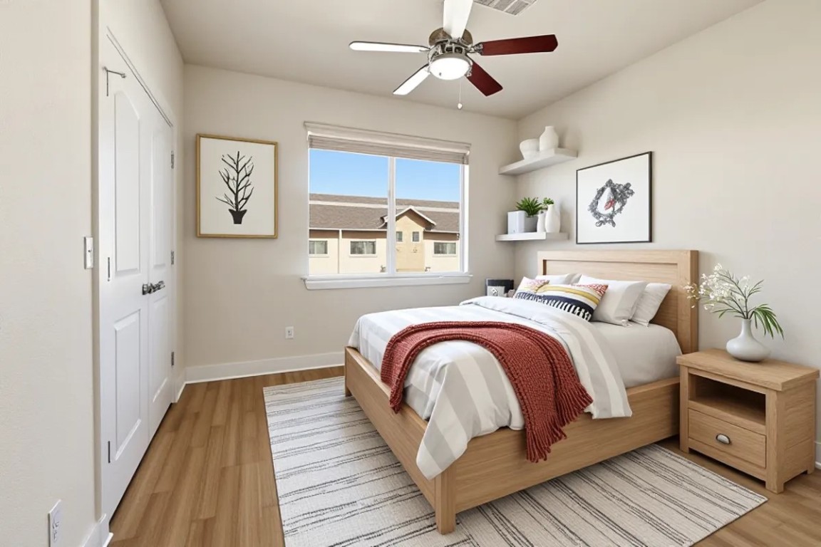 13420 Lyndhurst Street, Unit 807 Austin, TX 78729 - Photo 19 of 29 a bedroom with a bed and wooden floor