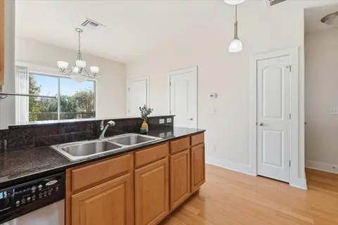 a kitchen with a sink cabinets and window