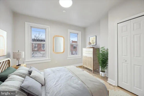 a bedroom with furniture and a large window