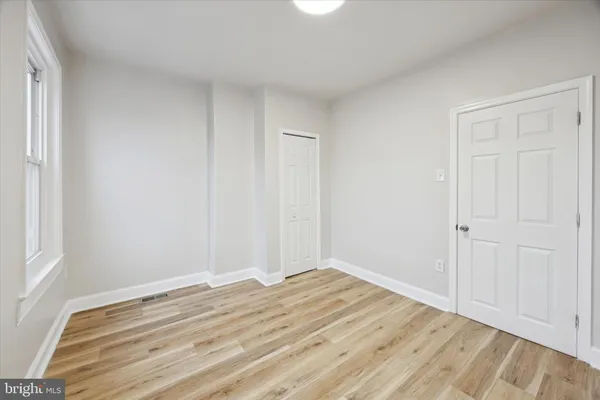 a view of a room with wooden floor and closet