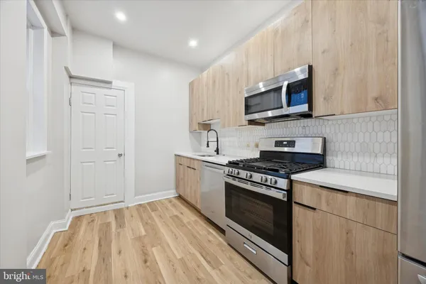 a kitchen with a stove and a microwave