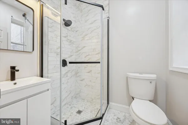 a bathroom with a toilet a sink and shower