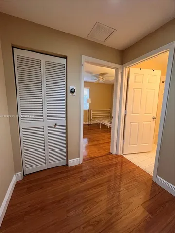 a room with wooden floor and white walls