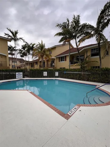 a view of a yard with furniture and garden