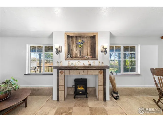 a living room with furniture a window and a fireplace
