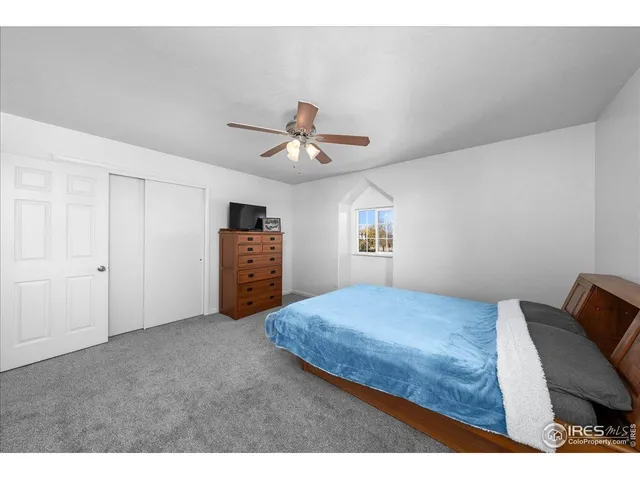 a living room with furniture and a ceiling fan