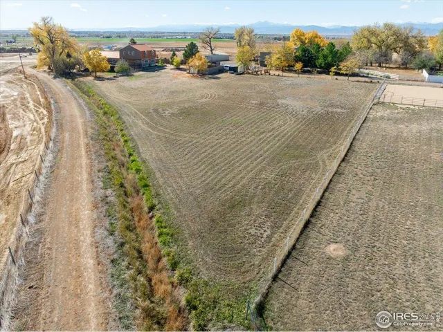 a view of a house with wooden fence