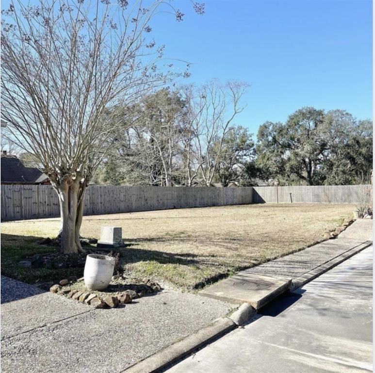 a view of a tree with wooden fence