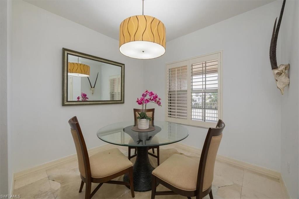 410 Bayfront Place, Unit 2405 Naples, FL 34102 - Photo 6 of 22 a dining room with furniture and wooden floor