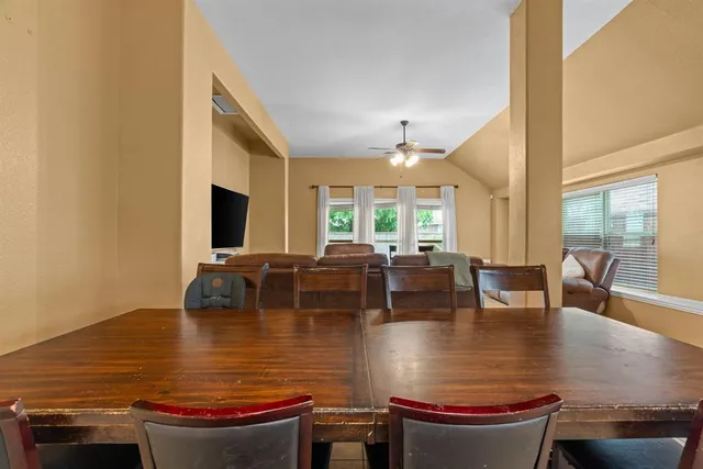 a view of a dining room and livingroom with furniture and window