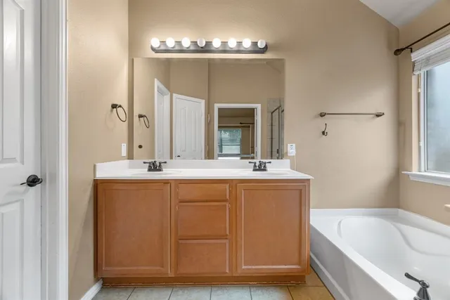 a bathroom with a bathtub and a shower