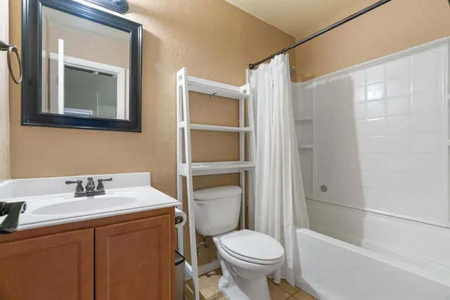a spacious bedroom with a bed and a chandelier