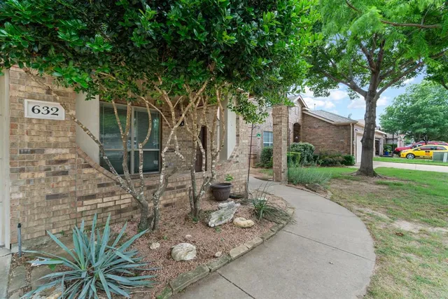 a view of a backyard with table and chairs and potted plants